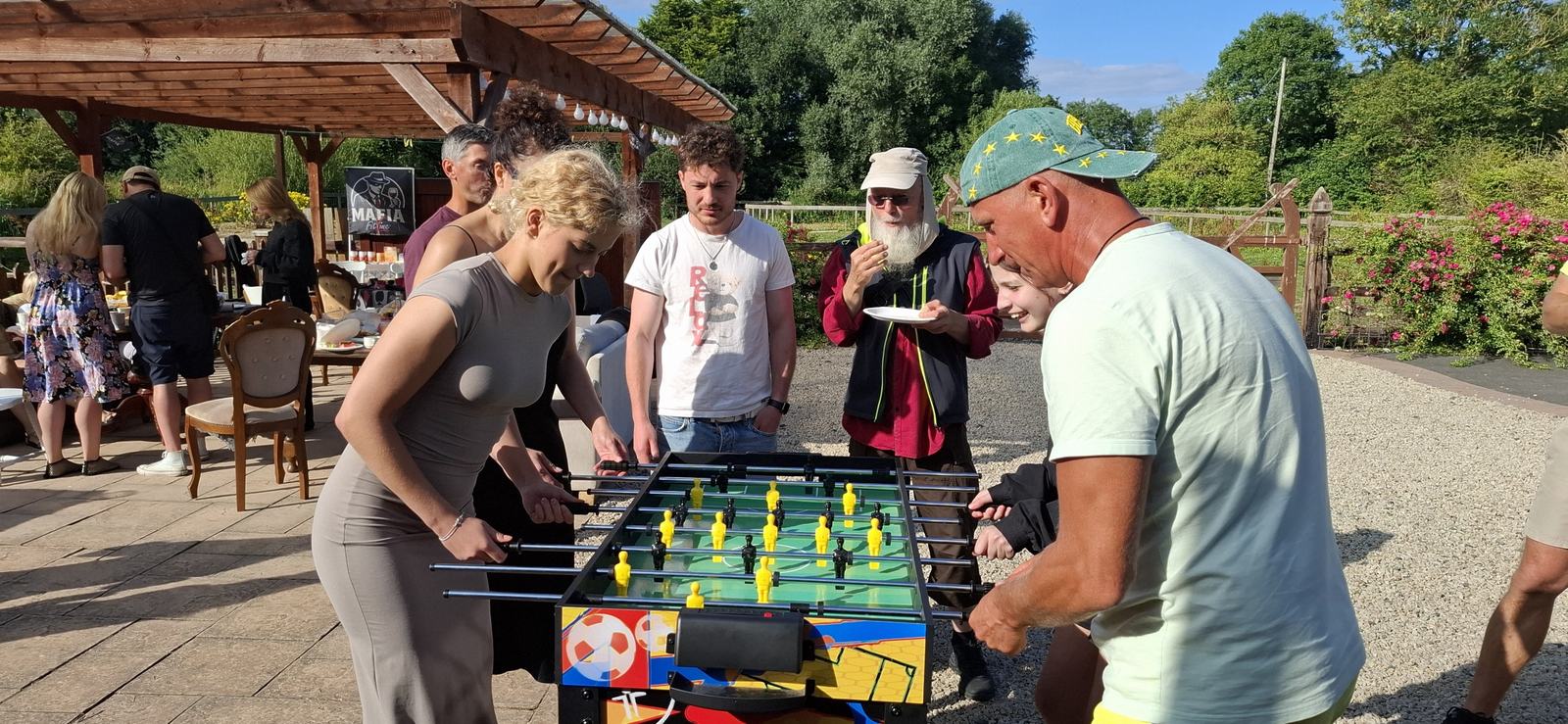 Guests playing table football at the picnic