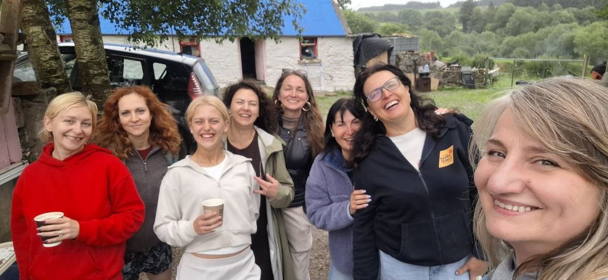 A group of friends smiling for a selfie at the nature day
